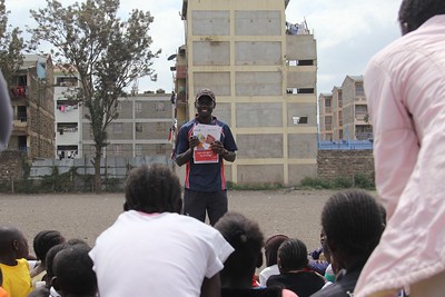 Nicholas holding cards showing HIV myth